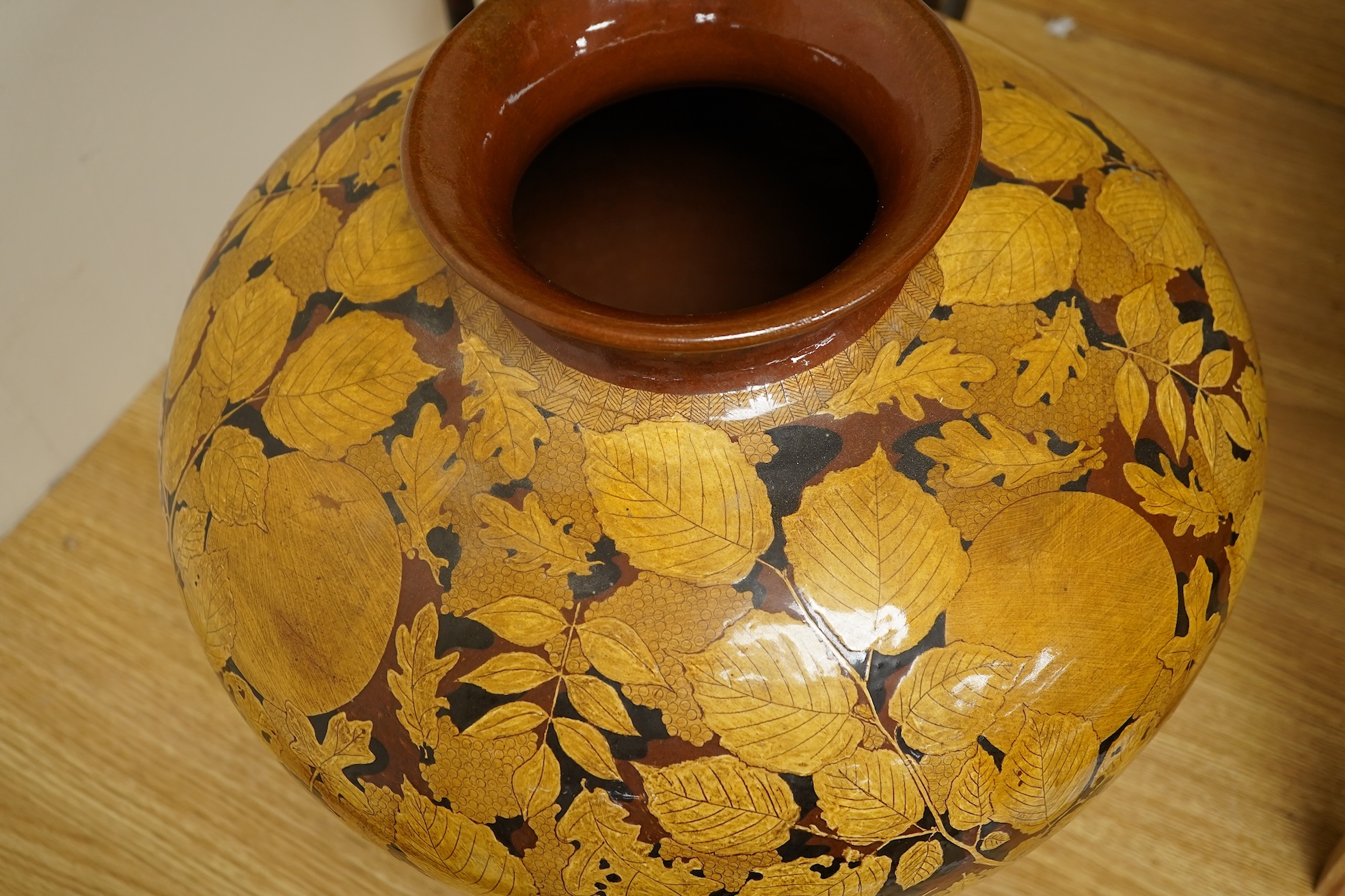 A large terracotta foliaiate decorated vase, 38cm high